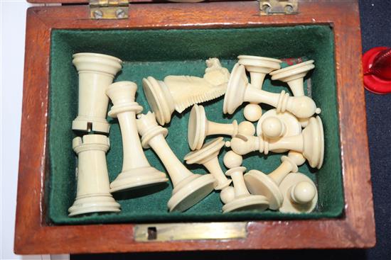 A small Staunton type ivory chess set, in mahogany box, kings 2.5in., missing one red pawn and the red king